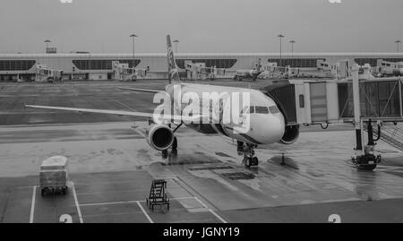 Kuala Lumpur, Malaysia - Dec 16, 2015. An aircraft with gangway at the KLIA Airport in Kuala Lumpur, Malaysia. KLIA is the world 23rd-busiest airport  Stock Photo