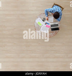 Businessman working with finance documents at office with laptop, and graph data papers on his desk, top view with copy space Stock Photo