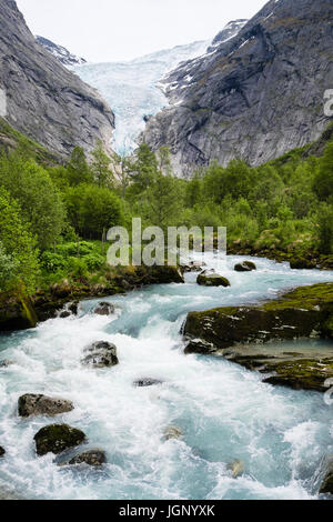 View along river to Briksdalsbreen or Briksdal glacier arm of Jostedalsbreen glacier in Briksdalen in Jostedalsbreen National Park in summer. Norway Stock Photo