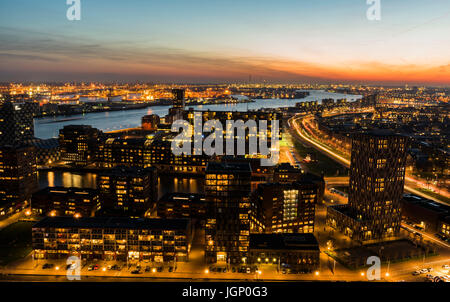 Rotterdam, The Netherlands - March 24, 2017: Nieuwe Maas in Evening Light with ships on the river, industrial areas and the harbor of Rotterdam in the Stock Photo