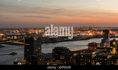 Nieuwe Maas in Evening Light with ships on the river, industrial areas and the harbor of Rotterdam in the Netherlands. Stock Photo