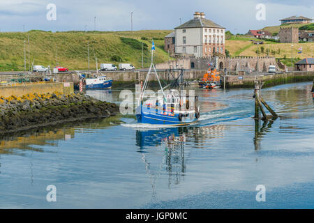 Eyemouth, Scotland, UK - July 18, 2016: A small fishing boat leaving the harbour in Eyemouth in the Scottish Borders. Stock Photo