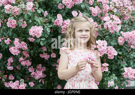 Girl in pink dress with roses Stock Photo