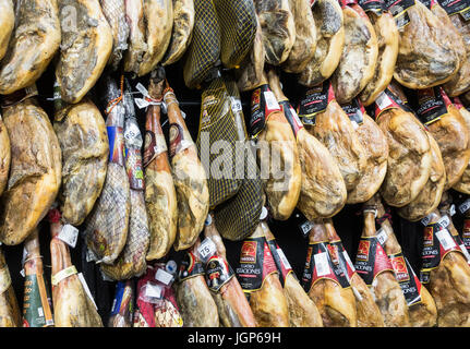 Spanish hams ( Jamon Iberico ) hanging in supermarket in Spain Stock Photo