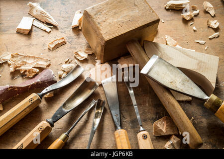 Various woodworking tools on a workbench, wooden mallet and wood carving knives, wooden mask carver, Bad Aussee, Styria, Austria Stock Photo