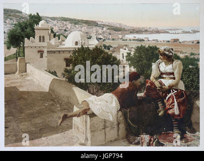 Moorish woman and child, terrace in Algiers. Algeria (ca.1899). Photochrome print. Part of a photo album. Stock Photo