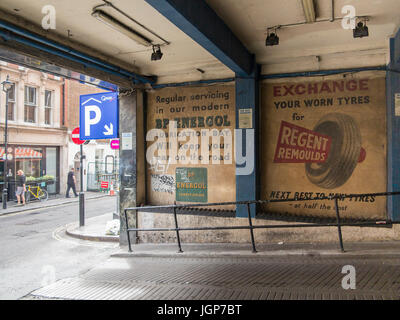 Old ghost signs for car parts in Soho, London Stock Photo