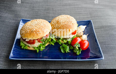 Healthy fast food burgers, homemade rye buns with sesame, burger with beluga lentils and hemp seeds, on canvas background Stock Photo