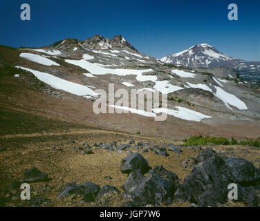 USA, Oregon, Deschutes National Forest, Three Sisters Wilderness, Broken Top and South Sister with lingering snow from previous winter, view northwest