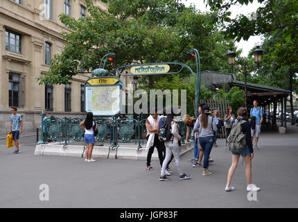 PARIS - AUG 8:  A woman looks at a map at the Paris Metro stop near Notre Dame in Paris, France on August 8, 2016. The transit system has 303 stations Stock Photo