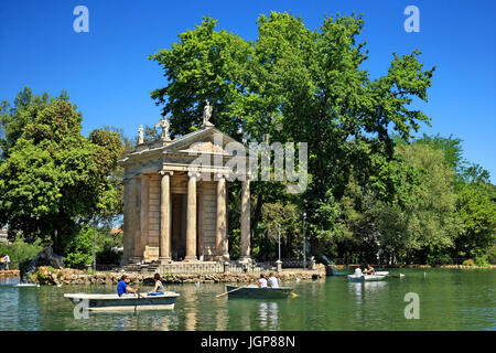 Visitors rowing their boats in the lake of the Villa Borghese gardens, next to the 18th century 'Temple of Asclepius (Aesculapius), Rome, Italy Stock Photo