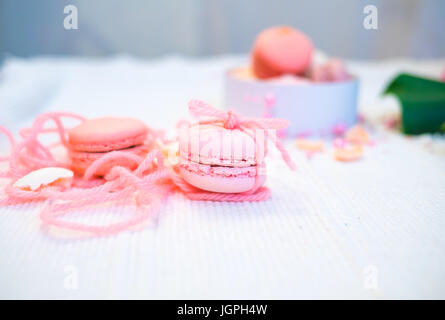 Pastel pink and rose macaroons in a white deep paper bowl Stock Photo