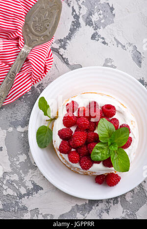cake with raspberry and cream on a table Stock Photo
