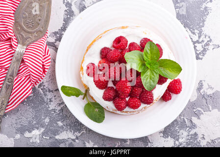 cake with raspberry and cream on a table Stock Photo