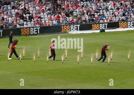 Chester le Street, UK. 09th July, 2017. Durham batsmen Adam Hickey and Graham Clark making their way to the wicket through pyrotechnics at the start of their match against Northamptonshire in the Natwest T20 Blast at the Emirates Riverside. Durham mascot Chester the Lion is following them. Credit: Colin Edwards/Alamy Live News Stock Photo