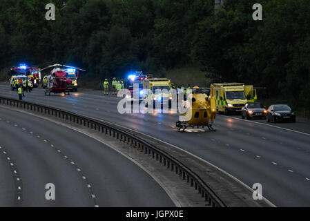 Accident closed M11 near Bishops Stortford, Harlow, Essex, UK. Three people taken to hospital. Two air ambulance helicopters attended, supporting numerous ground units. Man was charged with drink driving Stock Photo