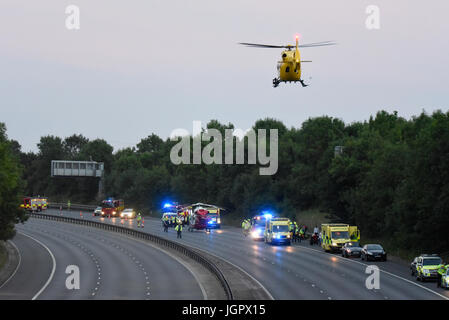 Accident closed M11 near Bishops Stortford, Harlow, Essex, UK. Three people taken to hospital. Two air ambulance helicopters attended, supporting numerous ground units. Man was charged with drink driving Stock Photo