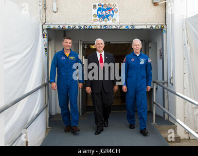 In this photo released by the National Aeronautics and Space Administration (NASA) United States Vice President Mike Pence, center, and NASA astronaut Reid Wiseman, left, and NASA astronaut Pat Forrester, right, walk out of the historic crew doors at Kennedy Space Center's (KSC) Operations and Checkout Building on Thursday, July 6, 2017, in Cape Canaveral, Florida. These are the same doors that Apollo and space shuttle astronauts walked through on their way to the launch pad. Mandatory Credit: Aubrey Gemignani/NASA via CNP /MediaPunch Stock Photo