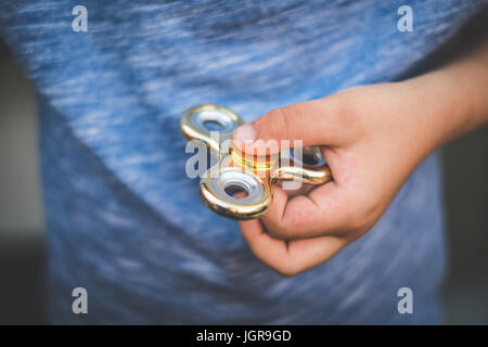 fidget, finger spinner - child holding fidget, finger spinner Stock Photo