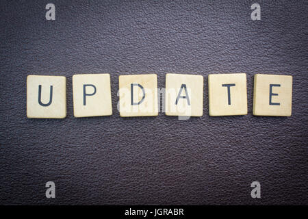 Update word concept for website on dark leather background Stock Photo