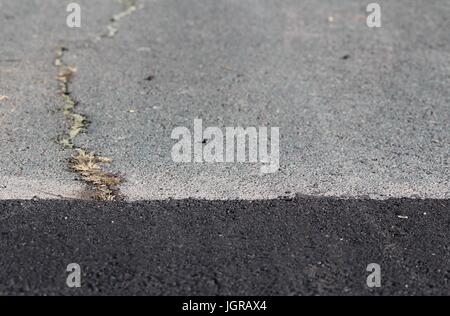 New and old road surface junction Stock Photo