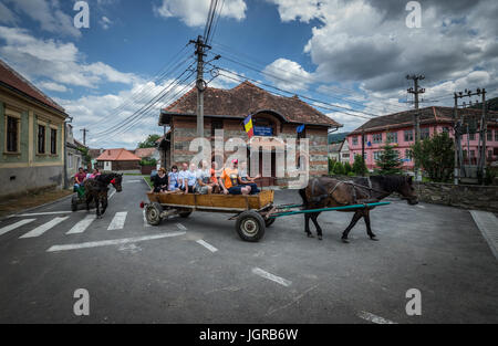 Tourist horse wagon ride in Sibiel villege famous from traditional Transylvanian Saxons architecture, Transylvania region in Romania Stock Photo