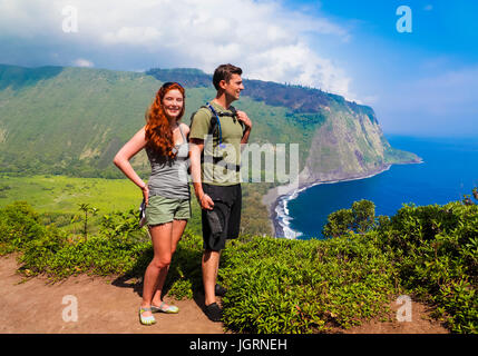 Hikers by road into Waipio Valley on the Big Island of Hawaii Stock Photo