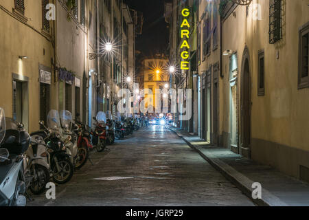 FLORENCE, ITALY - JULY 3:  Scooters line an alley in  Florence, Italy at night Stock Photo