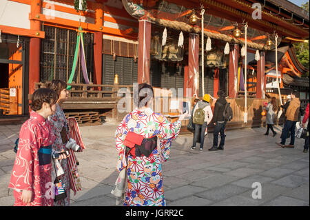 Kyoto, Japan - Young geishas at shrine in Maruyama park Stock Photo
