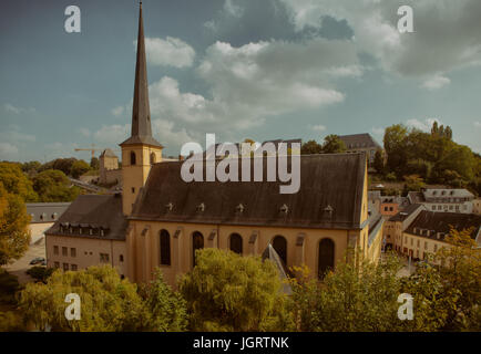 St. Jean du Grund, a catholic church originally built in 1606, sits on the banks of the Alzette River in Old Luxemborg City. Stock Photo