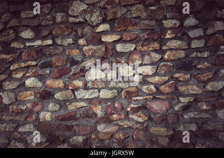 pattern of modern style design decorative uneven cracked real stone wall surface with cement Stock Photo