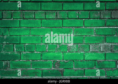 The green background of the old bricks. Painted green wall in grunge style or loft style. Stock Photo
