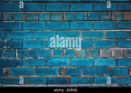 The green background of the old bricks. Painted green wall in grunge style or loft style. Stock Photo