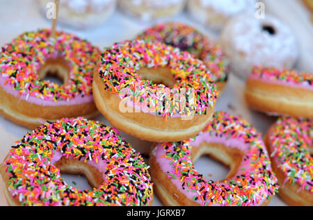 Homemade colorful donuts with chocolate and icing glaze, sweet icing sugar food Stock Photo