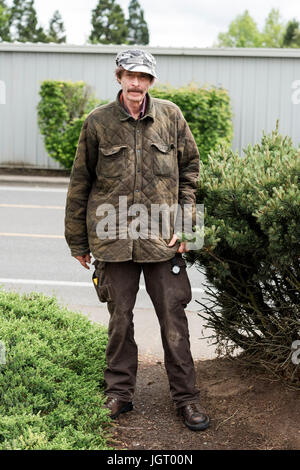 Elderly man with a unique sense of style outdoors for a lifestyle portrai in Oregon. Stock Photo