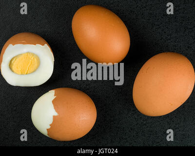 Four Fresh Hard Boiled Eggs Against a Black Background Stock Photo