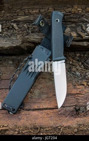 Sweden knife with plastic case. Brown wood. Stock Photo