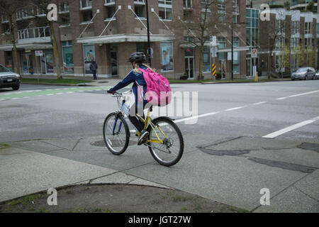Girl bicycling urban road 