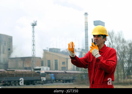 Portrait of a worker using walkie-talkie in sugar refinery. Stock Photo