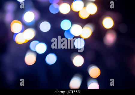 Christmas background. Festive abstract holidays background with bokeh defocused lights and stars. Purple, lilac, violet color, toned. blurred circles  Stock Photo