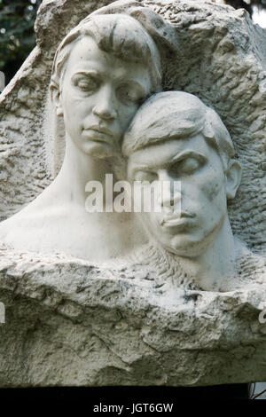 Grieving young couple statue Novodevichy Cemetery, Moscow, Russia Stock Photo