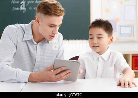 Male teacher helping student study Stock Photo