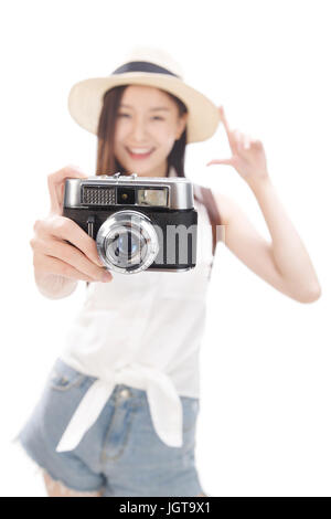 Young woman taking photograph with camera, portrait Stock Photo