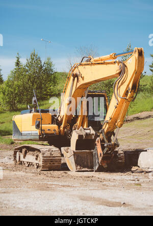 Yellow excavator on construction site. Stock Photo