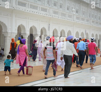 Amritsar, India - Jul 25, 2015. Indian people walking at the Golden Temple in Amritsar, India. Stock Photo