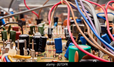 Close up of a circuit board with electrical components and colored cords Stock Photo