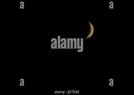 Waxing Crescent phase of the Moon in black sky background Stock Photo
