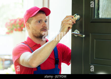 handyman fixing house door lock Stock Photo