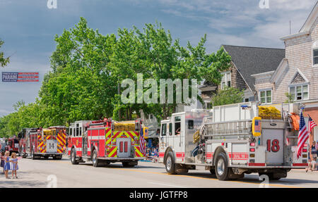 a line of local firetrucks in a fourth of july parade in Southampton, ny Stock Photo