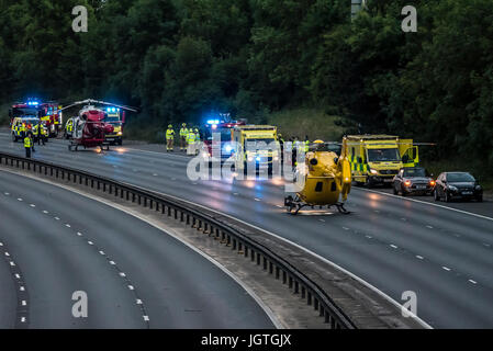 Accident closed M11 near Bishops Stortford, Harlow, Essex. Three people taken to hospital. Two air ambulances attended. Man charged with drink driving Stock Photo